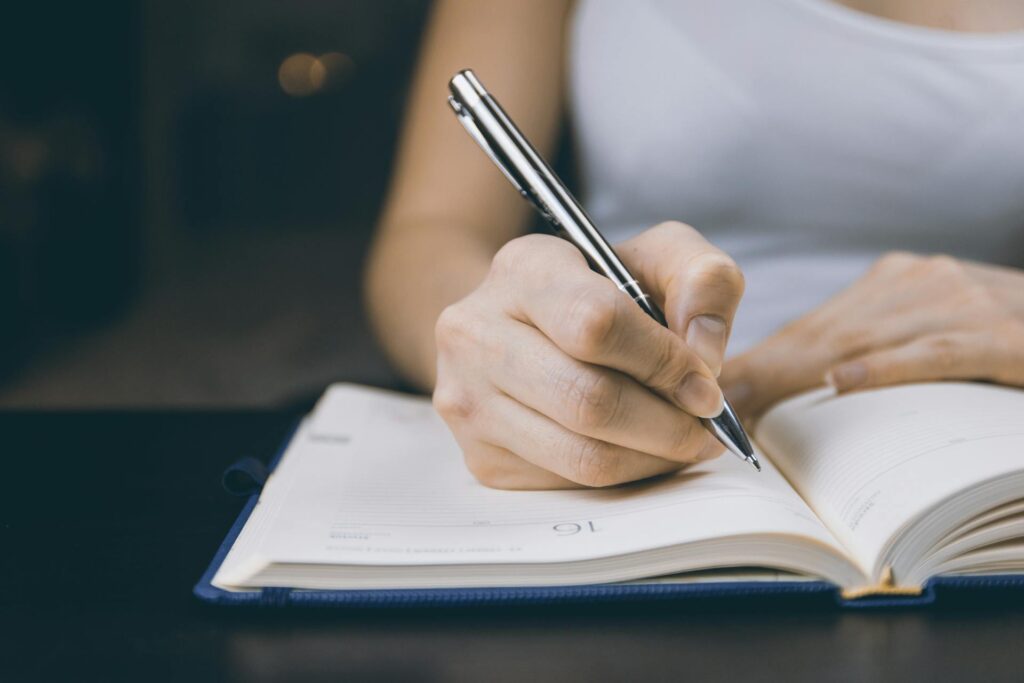 Woman Journaling To Manage Anxiety In A Relationship